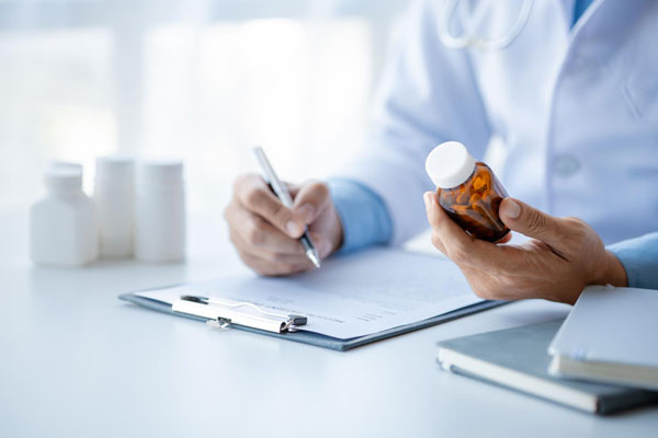 A doctor holding a bottle of medicine, ready to provide medical treatment and care.